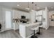 Modern kitchen with white island, stainless steel appliances, and quartz countertops at 6727 Canosa St, Denver, CO 80221