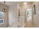 Bright upstairs hallway with white railings and doors at 6727 Canosa St, Denver, CO 80221