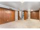 Finished basement featuring wood paneled walls and plush carpet at 588 Empire St, Aurora, CO 80010