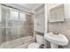 Bathroom featuring tile surround tub, storage, sink with vanity, mirror, and shower with glass doors at 588 Empire St, Aurora, CO 80010