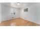 Bright bedroom with hardwood floors, white walls, and natural light from windows at 588 Empire St, Aurora, CO 80010
