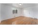 This bright bedroom offers hardwood floors, a white door and a window with exterior views at 588 Empire St, Aurora, CO 80010