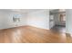 Spacious living room featuring hardwood floors, white walls, and ample natural light from a window at 588 Empire St, Aurora, CO 80010