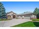 Charming single-Gathering home featuring stone accents, a three-car garage, and a well-manicured front yard at 6703 S Yates Ct, Littleton, CO 80128