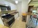 Galley kitchen with stainless steel appliances and granite countertops at 6725 W 55Th Ave, Arvada, CO 80002