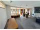 An open floorplan living room featuring a connecting kitchen with stainless steel appliances at 6725 W 55Th Ave, Arvada, CO 80002