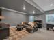 Finished basement featuring modern gray couches, a large round table, and recessed lights at 221 Felicity Loop, Castle Rock, CO 80109