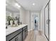 Spacious bathroom featuring double sinks, a sleek vanity, and a glass-enclosed shower for a spa-like experience at 221 Felicity Loop, Castle Rock, CO 80109