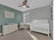 Charming Bedroom features a crib, changing table, and accent wall, creating a soothing environment at 221 Felicity Loop, Castle Rock, CO 80109