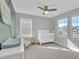 Inviting Bedroom filled with natural light has a crib, dresser, and chair, creating a cozy and functional space at 221 Felicity Loop, Castle Rock, CO 80109