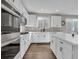 Bright kitchen with white cabinets, countertops, and stainless steel appliances at 221 Felicity Loop, Castle Rock, CO 80109