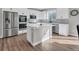 Modern kitchen with white cabinets, an island, and stainless steel appliances at 221 Felicity Loop, Castle Rock, CO 80109