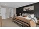 Cozy main bedroom with a full bed, bedside tables, and black accent wall, creating a stylish retreat at 221 Felicity Loop, Castle Rock, CO 80109