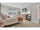 Bright bedroom with two windows, TV, dresser, and full-length mirror offers comfortable living space at 221 Felicity Loop, Castle Rock, CO 80109