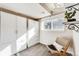 Charming bedroom with custom closet, a relaxing chair, and abundant natural light from the nearby window at 8408 Wild Alfalfa Pl, Parker, CO 80134