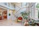 Bright entryway with high ceilings, staircase, tiled floor, and large windows that offer plenty of natural light at 5398 S Jay Dr, Littleton, CO 80123