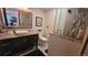 Well-lit bathroom featuring a modern vanity and a sleek, glass-enclosed shower at 442 S Carr St, Lakewood, CO 80226