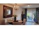 Cozy dining room featuring chandelier lighting, a decorated mirror, and patio access at 442 S Carr St, Lakewood, CO 80226