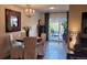 Cozy dining room with chandelier, seating for four, and sliding glass doors to the outside patio at 442 S Carr St, Lakewood, CO 80226