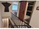 Staircase and hallway leading to a bedroom and bathroom with a unique barn door at 442 S Carr St, Lakewood, CO 80226