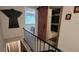 Staircase and hallway leading to a bedroom and bathroom with a unique barn door at 442 S Carr St, Lakewood, CO 80226