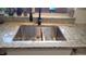Stainless steel kitchen sink with granite countertops and modern fixtures under the window at 442 S Carr St, Lakewood, CO 80226