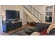 Inviting living room with a staircase, a mounted TV, and stylish furnishings at 442 S Carr St, Lakewood, CO 80226
