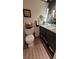 Well-appointed powder room with custom vanity, toilet, and a decorative mirror at 442 S Carr St, Lakewood, CO 80226