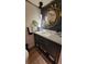 Stylish powder room with custom vanity, unique mirror, and elegant lighting at 442 S Carr St, Lakewood, CO 80226
