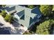 Aerial view of home with a well-maintained green roof, set amidst mature trees and lush landscaping at 640 S Yarrow St, Lakewood, CO 80226