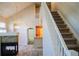 Bright foyer showcasing the staircase, wood-look flooring, and stone fireplace at 640 S Yarrow St, Lakewood, CO 80226