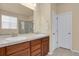 Bathroom featuring double sinks, tile counters, and a view into the shower at 1533 Bellflower Dr, Brighton, CO 80601