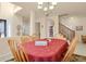 Spacious dining room featuring tile flooring, access to the staircase, and neutral colored walls at 1533 Bellflower Dr, Brighton, CO 80601