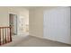 Upstairs hallway with neutral carpet, white doors, and access to rooms at 1533 Bellflower Dr, Brighton, CO 80601