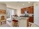 Well-equipped kitchen island, stainless steel appliances, and an adjacent dining area at 1533 Bellflower Dr, Brighton, CO 80601