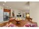Spacious living area with a fireplace, seamless to the kitchen with updated stainless appliances at 1533 Bellflower Dr, Brighton, CO 80601