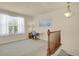 A versatile loft space with neutral carpet, ample natural light, and railing at 1533 Bellflower Dr, Brighton, CO 80601