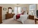 Comfortable main bedroom with a plush bed, wood furniture and natural light at 1533 Bellflower Dr, Brighton, CO 80601