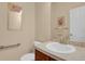 Well-maintained powder room with a sink, toilet and mirror at 1533 Bellflower Dr, Brighton, CO 80601
