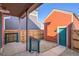 A small backyard with a coral colored garage and a small patio area at 10331 E 62Nd Pl, Denver, CO 80238