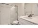 Bright bathroom with a glass-enclosed shower, white subway tiles, and a modern vanity with solid-surface countertop at 10331 E 62Nd Pl, Denver, CO 80238