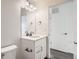 Modern bathroom with a bright vanity with a solid-surface countertop and contemporary hardware, next to a doorway at 10331 E 62Nd Pl, Denver, CO 80238