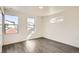 Bright bedroom with three windows, wood-look floors, and contemporary design elements for a simple and clean aesthetic at 10331 E 62Nd Pl, Denver, CO 80238