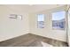 Light-filled bedroom with wood-look floors and dual windows, providing a comfortable and airy living space at 10331 E 62Nd Pl, Denver, CO 80238