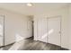 Bright bedroom featuring wood-look floors and large closet with paneled doors, perfect for storage and relaxation at 10331 E 62Nd Pl, Denver, CO 80238