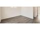 Neutral bedroom featuring wood floor and natural light from window at 10331 E 62Nd Pl, Denver, CO 80238