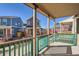 A front porch with a view of the neighborhood shows the blue house next door at 10331 E 62Nd Pl, Denver, CO 80238