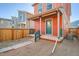 An orange house with a green door features a drought-resistant front yard at 10331 E 62Nd Pl, Denver, CO 80238