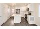 Contemporary kitchen featuring stainless steel appliances, white cabinets, and an island with room for seating at 10331 E 62Nd Pl, Denver, CO 80238