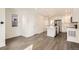 Open-concept kitchen and dining area featuring stainless steel appliances and white cabinets at 10331 E 62Nd Pl, Denver, CO 80238